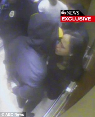 In custody: Ray Rice is seen being led away in handcuffs by police after the elevator attack  