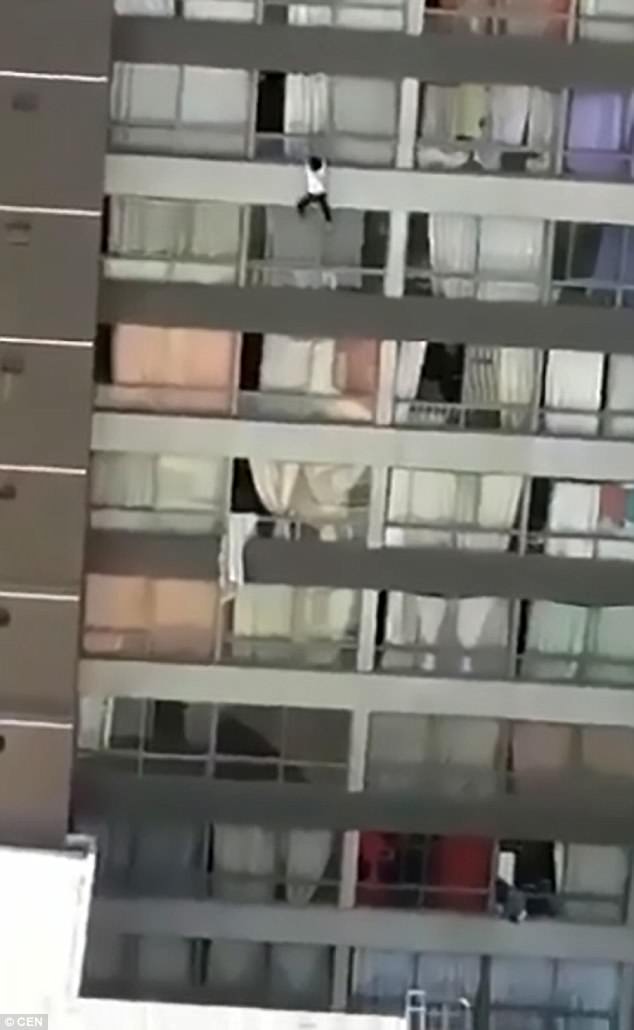 A woman hangs from a ninth-floor balcony in Chile, pictured, in an unconfirmed suicide attempt